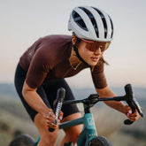 Frau fährt Fahrrad mit Rennrad Helm